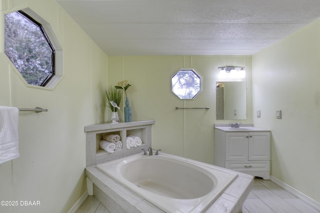 1420 Carol Lee St, Daytona Beach, FL 32117 - full bath with vanity, a garden tub, a textured ceiling, and baseboards