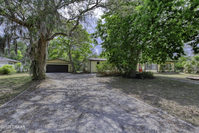 1420 Carol Lee St, Daytona Beach, FL 32117 - view of property hidden behind natural elements with a garage and an outdoor structure