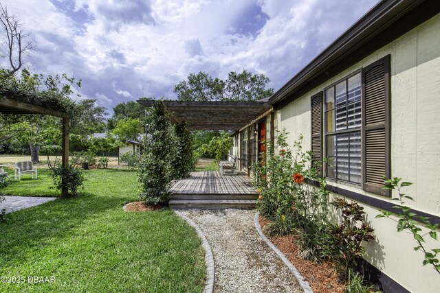 1420 Carol Lee St, Daytona Beach, FL 32117 - view of green lawn featuring a wooden deck and a pergola
