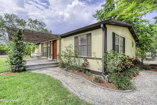 1420 Carol Lee St, Daytona Beach, FL 32117 - view of front facade with a deck, a pergola, and a front lawn