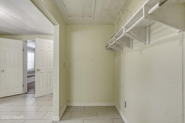 1420 Carol Lee St, Daytona Beach, FL 32117 - spacious closet featuring attic access and light tile patterned floors