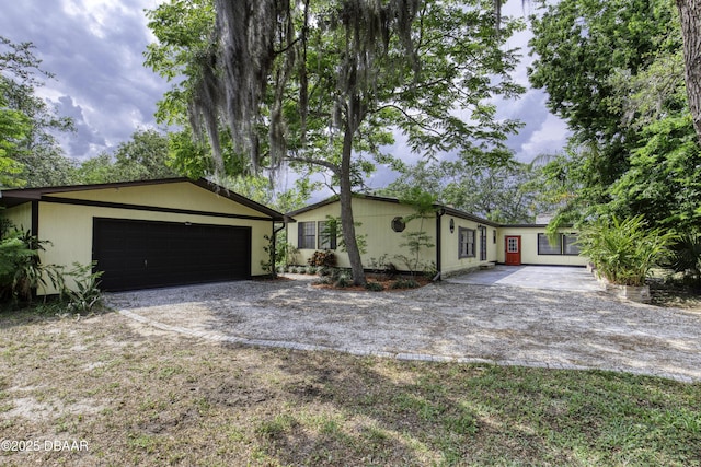 1420 Carol Lee St, Daytona Beach, FL 32117 - view of front of property featuring gravel driveway and an attached garage