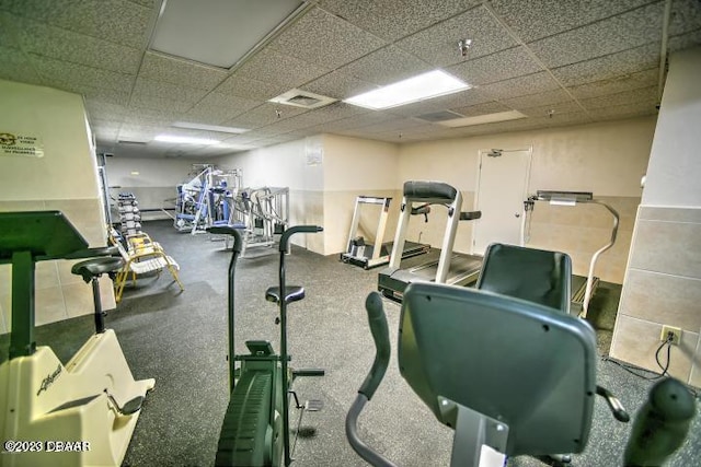 exercise room with a paneled ceiling