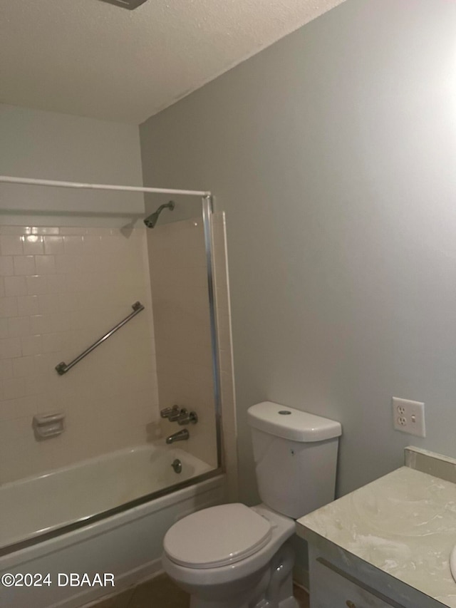 full bathroom featuring vanity, a textured ceiling, toilet, and shower / bathtub combination