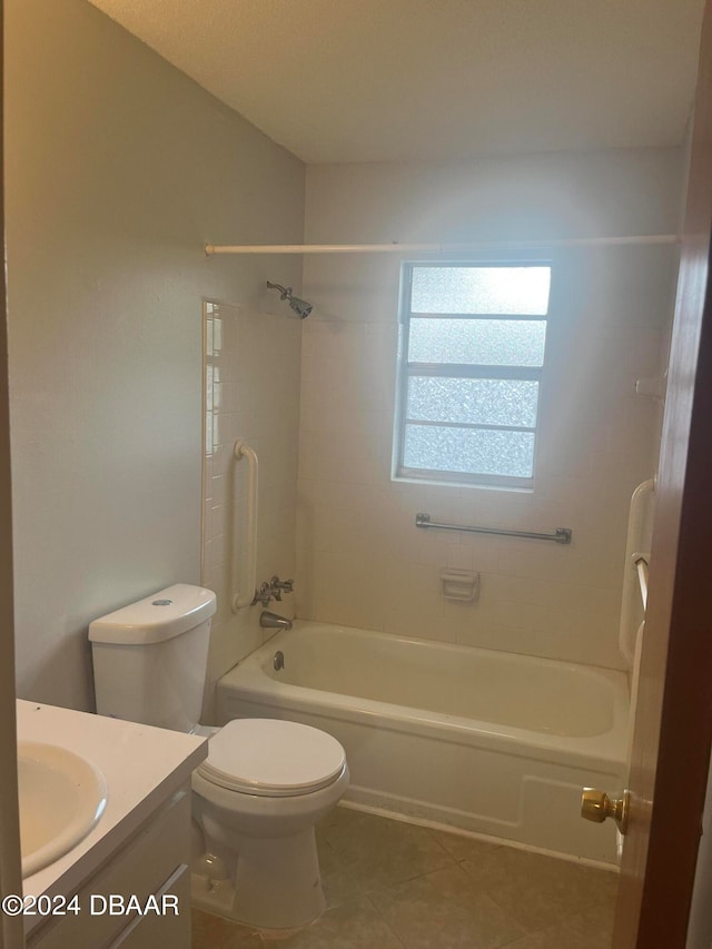 full bathroom featuring vanity, tile patterned floors, toilet, and tiled shower / bath combo