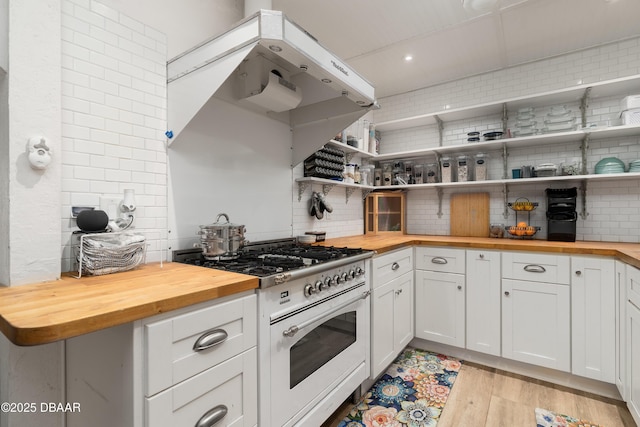 25 Dolphin Ave, Ormond Beach, FL 32176 - kitchen with wooden counters, range with gas stovetop, backsplash, open shelves, and recessed lighting