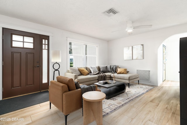 25 Dolphin Ave, Ormond Beach, FL 32176 - living room featuring light wood-type flooring, a ceiling fan, and arched walkways
