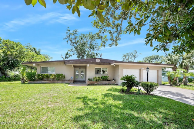 22 N St Andrews Dr, Ormond Beach, FL 32174 - ranch-style house with a garage, concrete driveway, and a front lawn