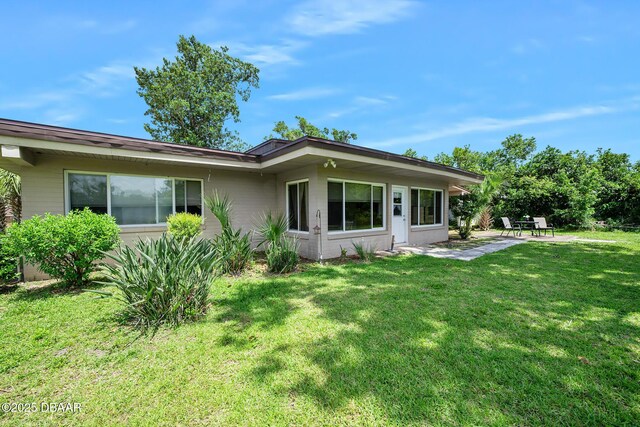 22 N St Andrews Dr, Ormond Beach, FL 32174 - back of house featuring a yard and a patio area