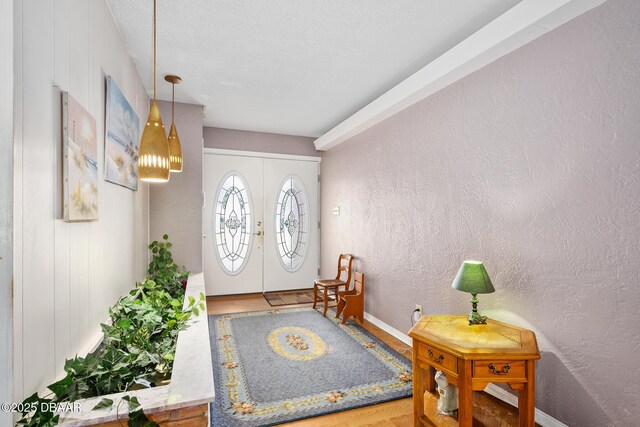 22 N St Andrews Dr, Ormond Beach, FL 32174 - entryway featuring wood finished floors, a textured wall, and french doors