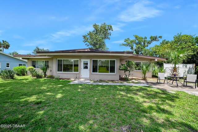 22 N St Andrews Dr, Ormond Beach, FL 32174 - rear view of house featuring a patio and a lawn