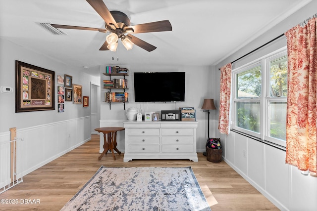 living room featuring ceiling fan and light hardwood / wood-style flooring