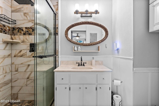 bathroom featuring vanity and a shower with shower door