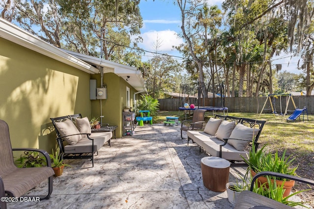 view of patio / terrace featuring a playground, outdoor lounge area, and a trampoline