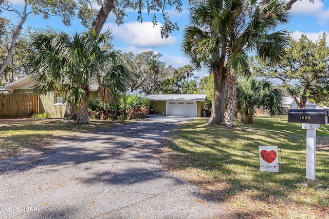 ranch-style house with a garage and a front lawn