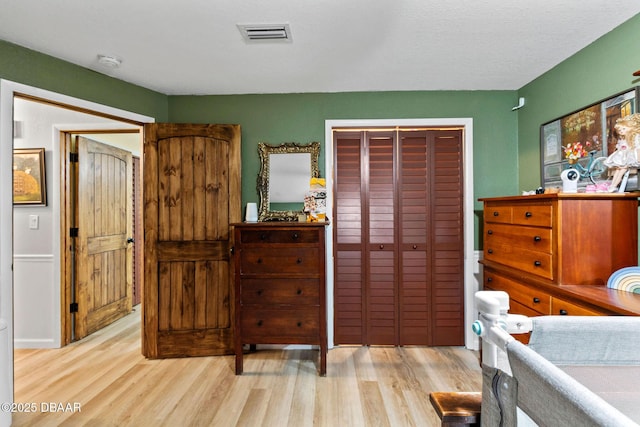 bedroom with a closet and light wood-type flooring