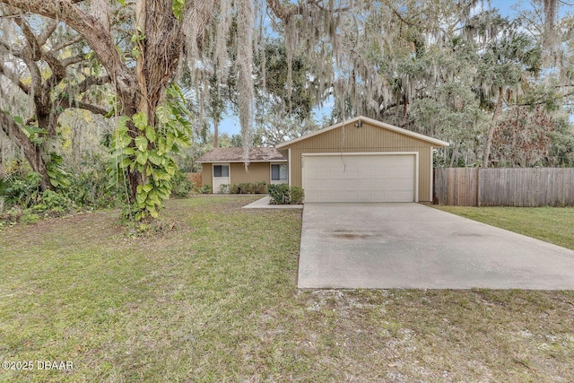 ranch-style house featuring a front yard and a garage