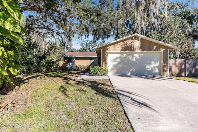 ranch-style home featuring a front lawn and a garage