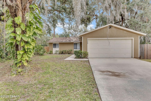 single story home with a garage and a front lawn