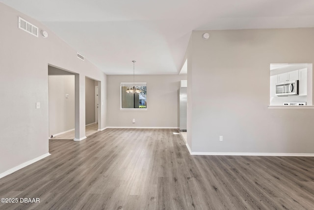 interior space with dark hardwood / wood-style floors and an inviting chandelier