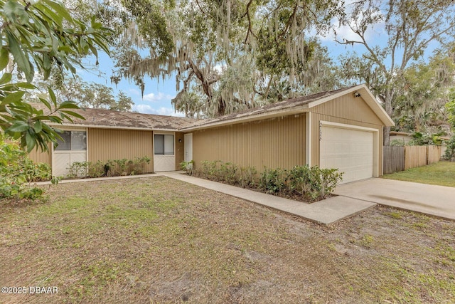 single story home featuring a garage and a front lawn