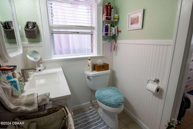 bathroom featuring tile patterned flooring, vanity, and toilet