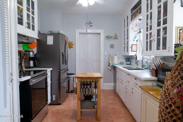 kitchen featuring ceiling fan, sink, light tile patterned floors, white cabinets, and appliances with stainless steel finishes