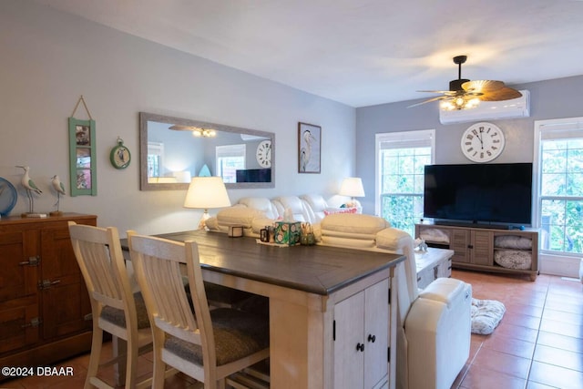 living room featuring ceiling fan, a healthy amount of sunlight, and light tile patterned flooring