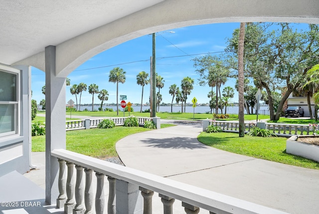 1650 Riverside Dr, Holly Hill, FL 32117 - surrounding community with a water view and a lawn