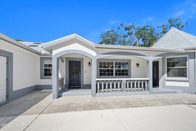 1650 Riverside Dr, Holly Hill, FL 32117 - doorway to property with a porch and stucco siding