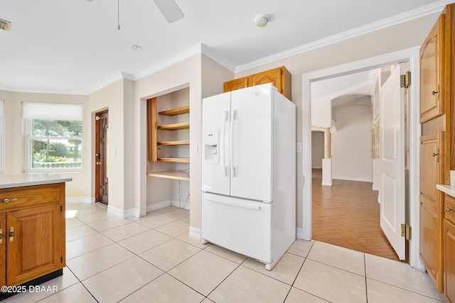 1650 Riverside Dr, Holly Hill, FL 32117 - kitchen featuring white fridge with ice dispenser, light countertops, ornamental molding, brown cabinetry, and ceiling fan