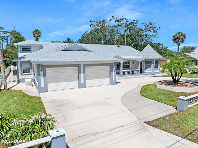 1650 Riverside Dr, Holly Hill, FL 32117 - ranch-style home with stucco siding, a garage, a porch, driveway, and roof with shingles