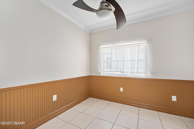 1650 Riverside Dr, Holly Hill, FL 32117 - tiled spare room with a ceiling fan, a wainscoted wall, and crown molding
