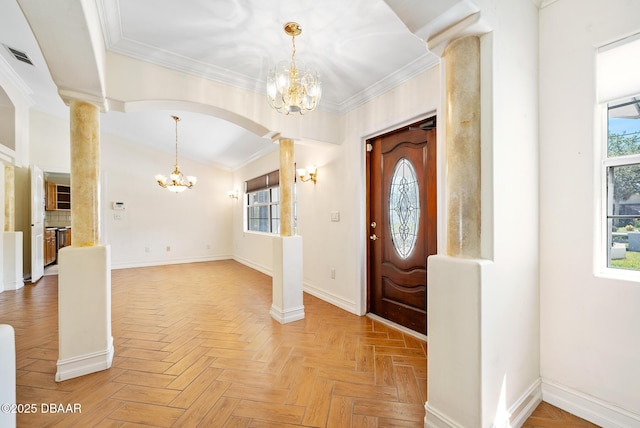 1650 Riverside Dr, Holly Hill, FL 32117 - foyer entrance featuring a chandelier, decorative columns, crown molding, and arched walkways