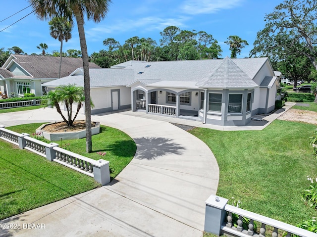 1650 Riverside Dr, Holly Hill, FL 32117 - ranch-style home with curved driveway, covered porch, stucco siding, and a shingled roof