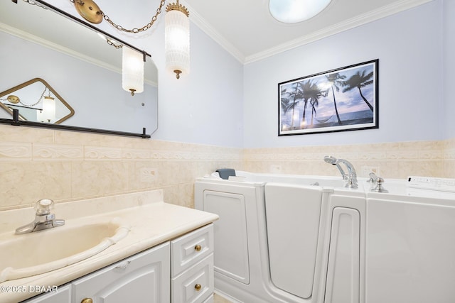 1650 Riverside Dr, Holly Hill, FL 32117 - bathroom with washer / dryer, vanity, tile walls, crown molding, and a garden tub