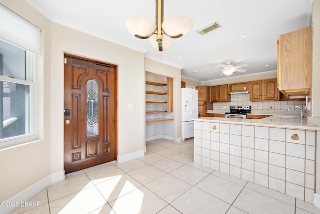 1650 Riverside Dr, Holly Hill, FL 32117 - kitchen featuring electric range, white fridge with ice dispenser, open shelves, light countertops, and a peninsula