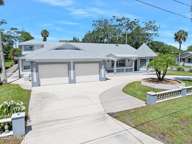 1650 Riverside Dr, Holly Hill, FL 32117 - single story home with a garage, stucco siding, roof with shingles, a porch, and concrete driveway