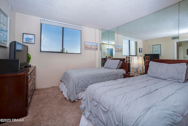 carpeted bedroom featuring a textured ceiling