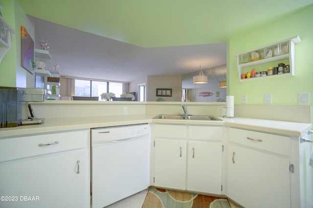 kitchen with kitchen peninsula, white cabinetry, sink, and dishwasher