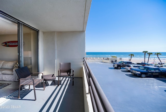 balcony with a view of the beach and a water view