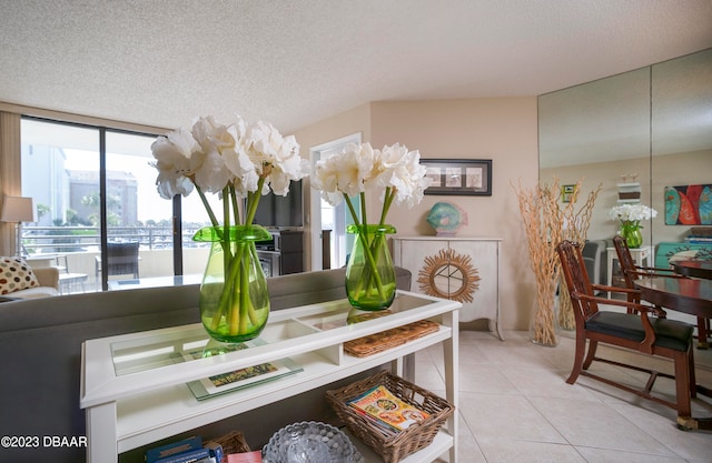 tiled dining area featuring a textured ceiling