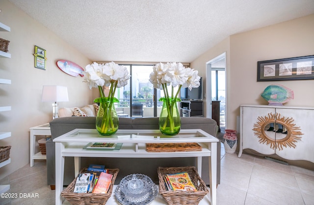 dining area with plenty of natural light, light tile patterned floors, and a textured ceiling