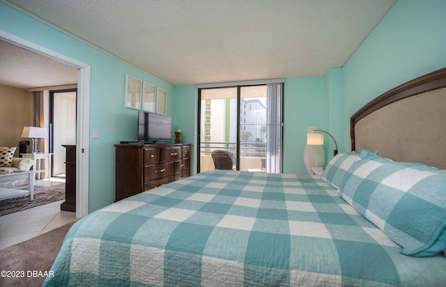 tiled bedroom featuring a textured ceiling and access to exterior