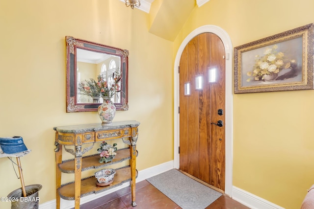 entryway featuring tile patterned flooring and crown molding