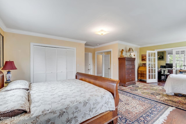 bedroom with a closet, french doors, and crown molding