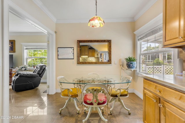 dining space featuring crown molding