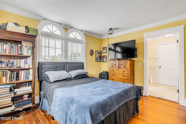 bedroom with hardwood / wood-style flooring and ornamental molding