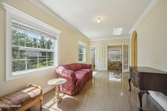 sitting room featuring a wealth of natural light, french doors, and crown molding