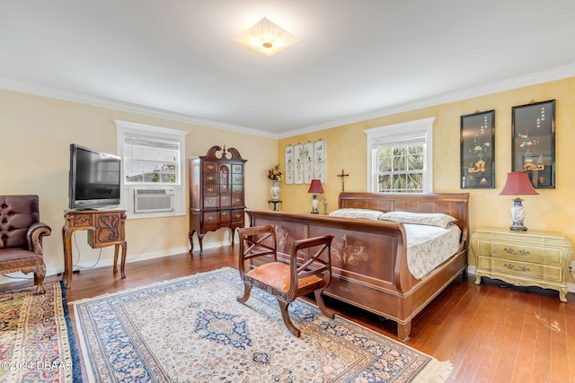 bedroom with hardwood / wood-style floors, cooling unit, and crown molding